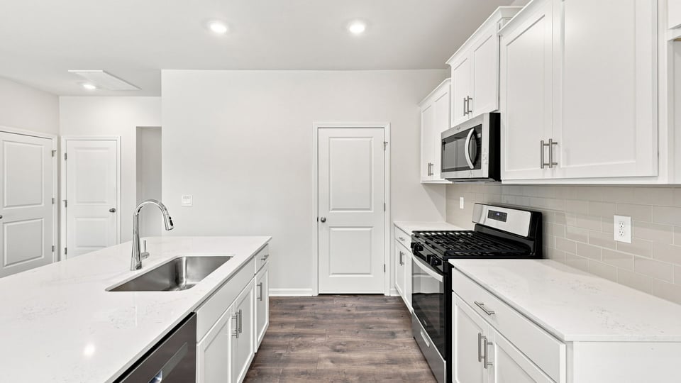 Kitchen with island and cabinets.