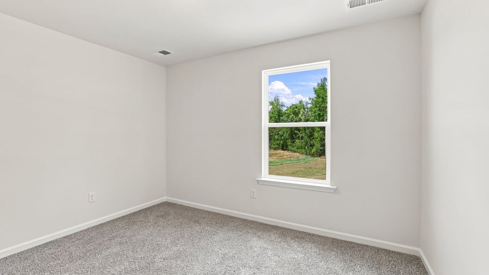 Bedroom with carpet and windows.