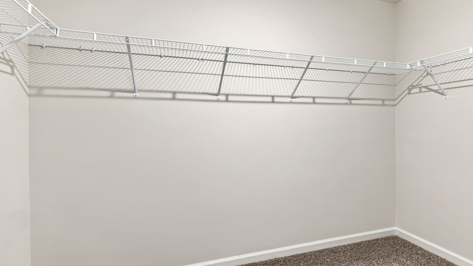 Primary closet with shelf.