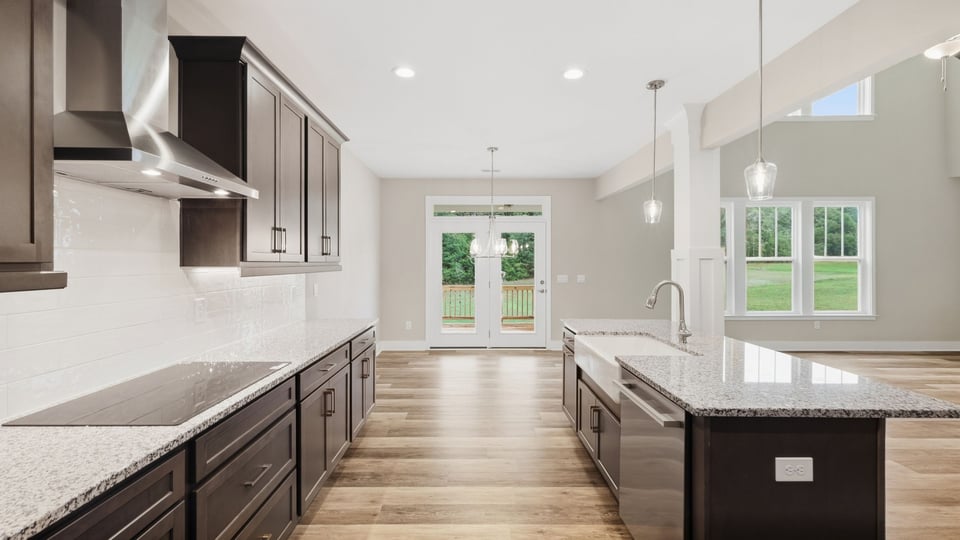 Kitchen and island with stainless steel appliances.
