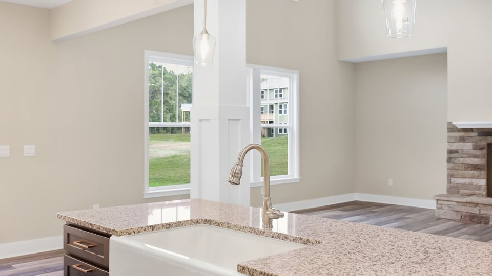 Kitchen and island with stainless steel appliances.