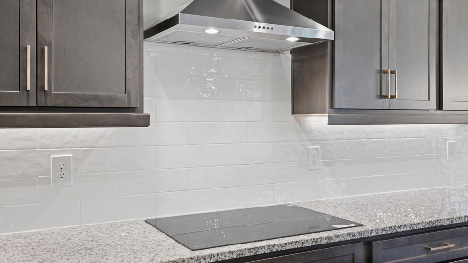 Kitchen and island with stainless steel appliances.