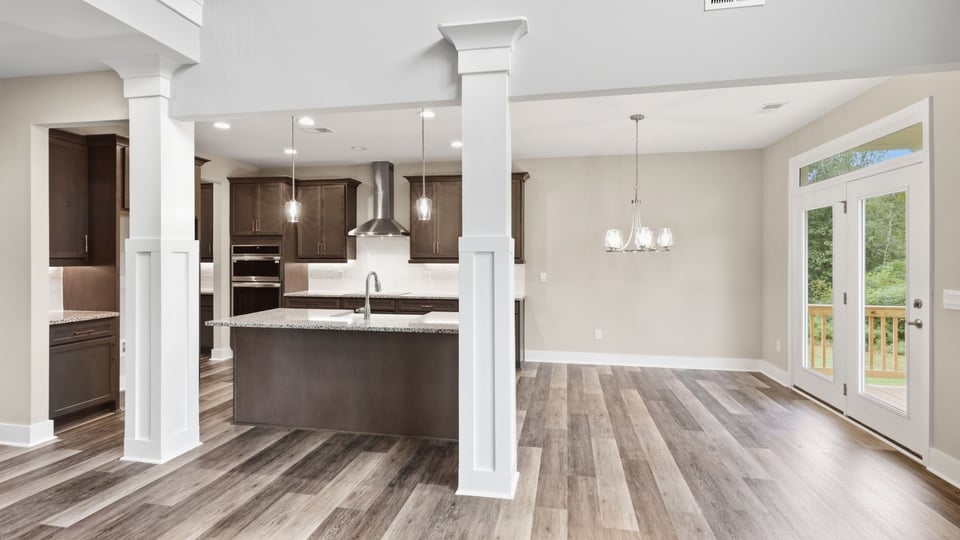 Kitchen and island with stainless steel appliances.