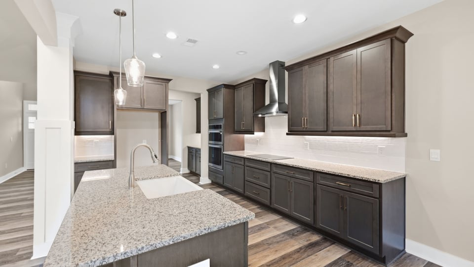 Kitchen and island with stainless steel appliances.