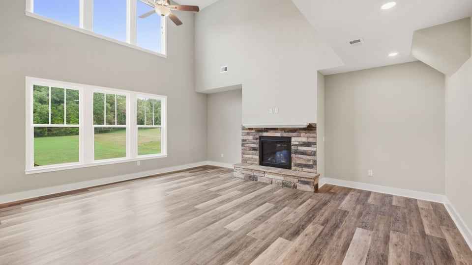 Living room with windows and fireplace.