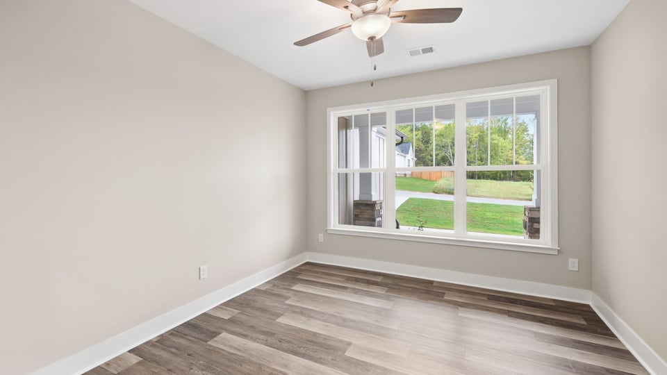 Living room with windows and fireplace.