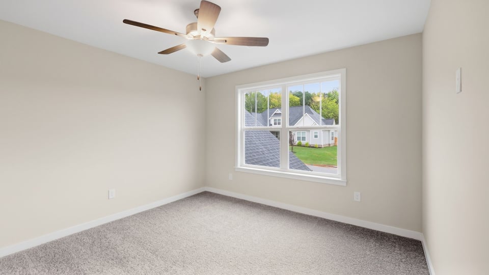 Bedroom with carpet and window.