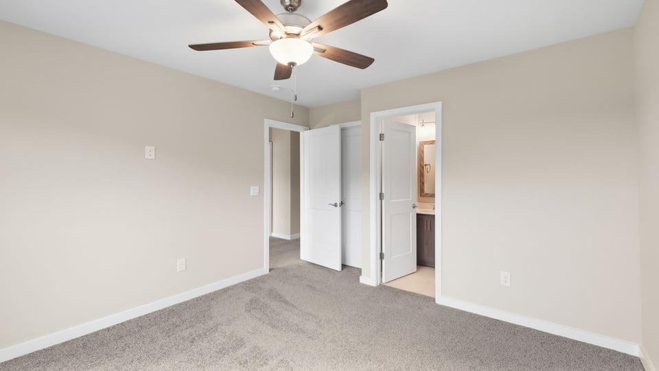 Bedroom with carpet and window.