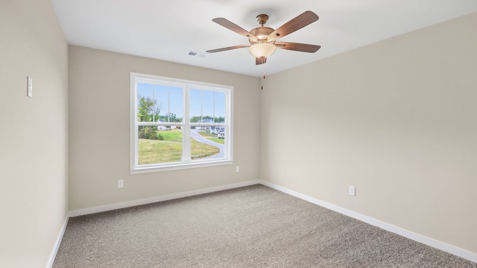 Bedroom with carpet and windows.