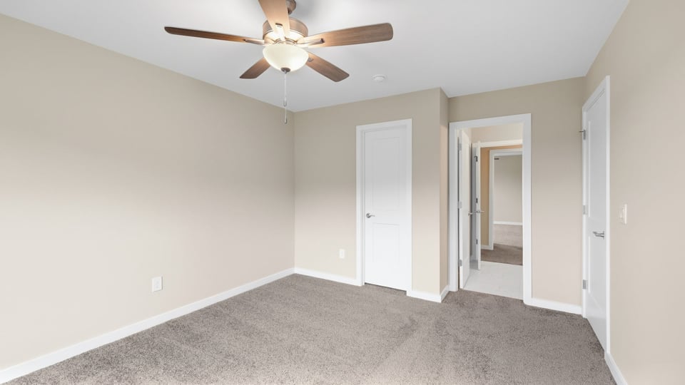 Bedroom with carpet and windows.