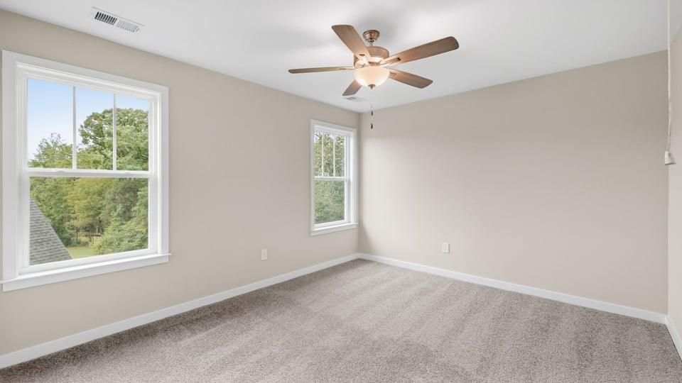 Bedroom with carpet and window.