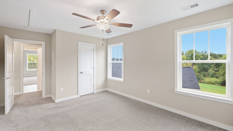 Bedroom with carpet and window.