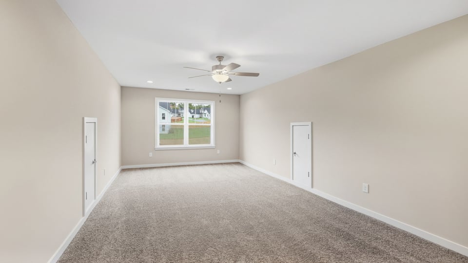 Bedroom with carpet and window.