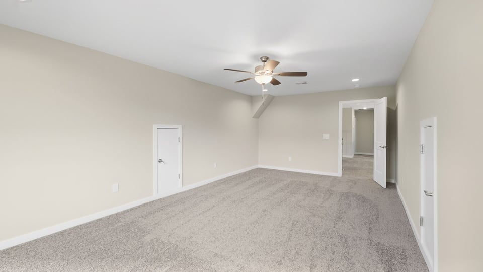 Bedroom with carpet and window.
