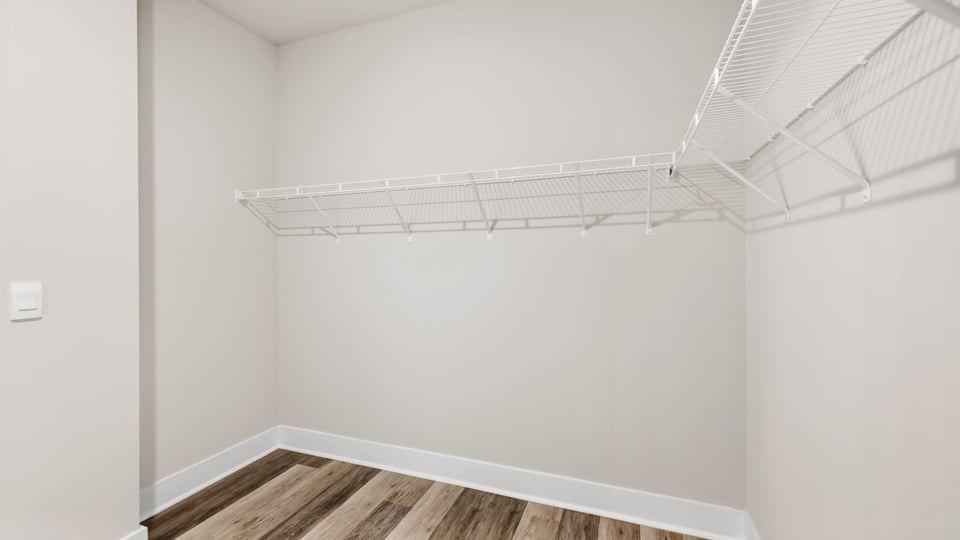 Walk in closet with storage racks.