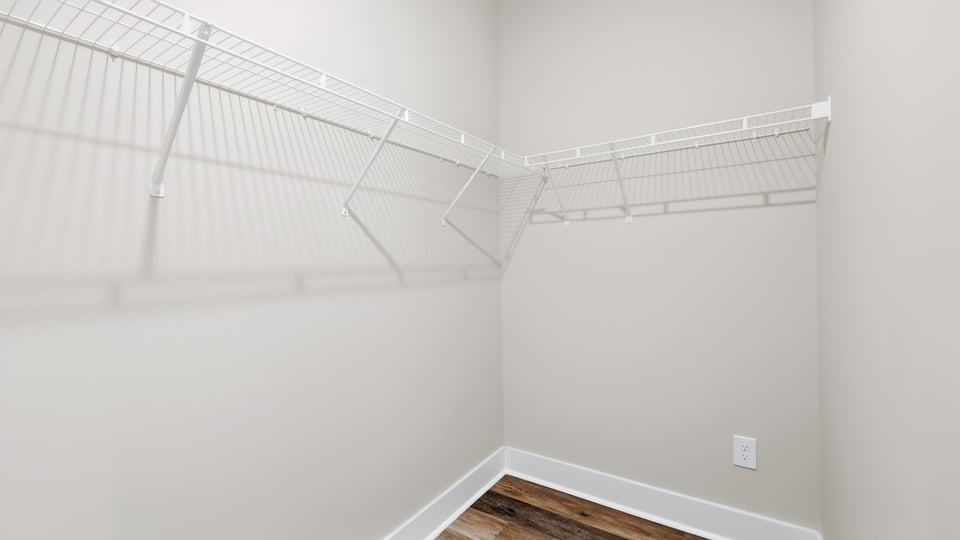 Walk in closet with storage racks.