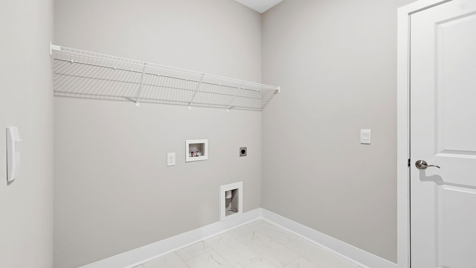 Laundry room with storage rcks.