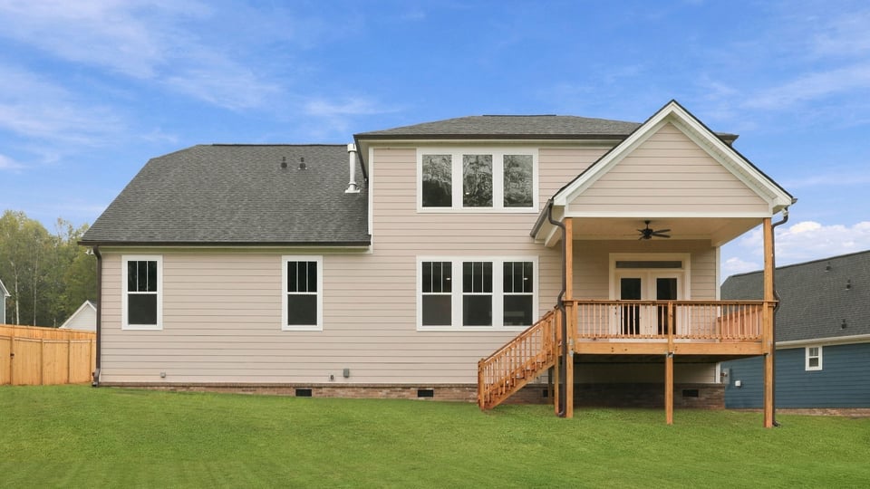Back exterior of home with large backyard.