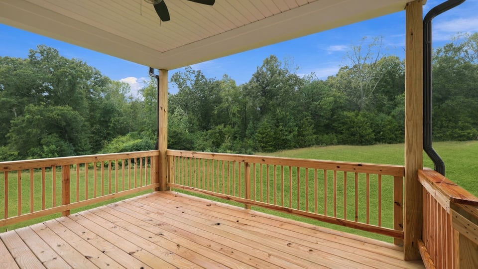 Back exterior of home with covered porch.