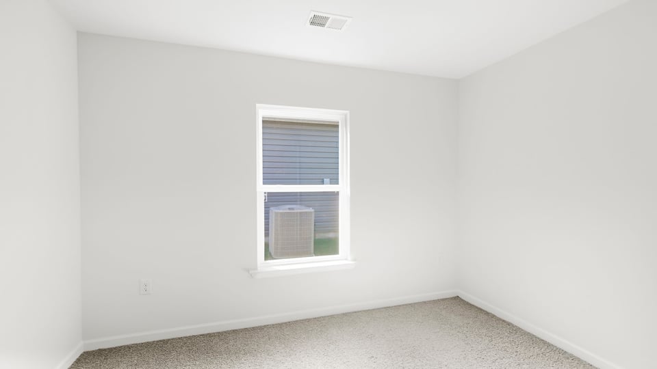 Bedroom with carpet and window.