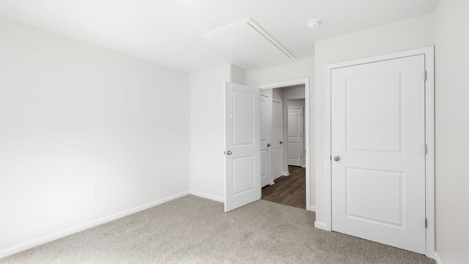 Bedroom with carpet and window.