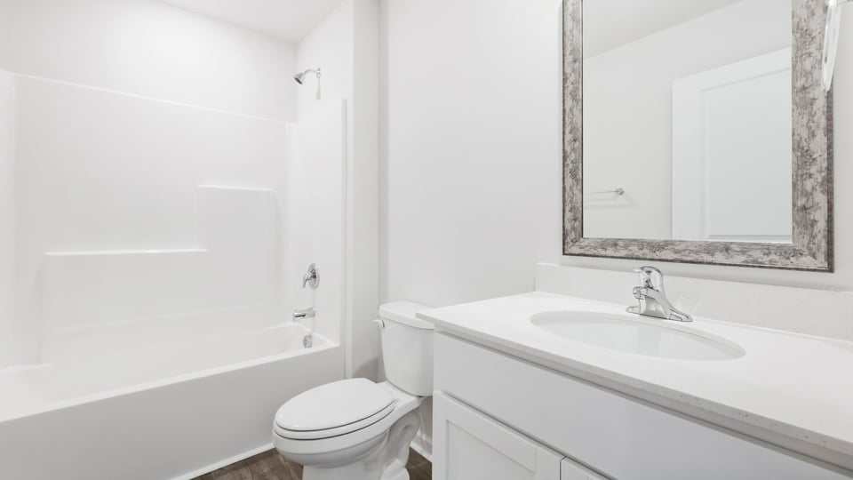 Bathroom with single vanity sink and bathtub.