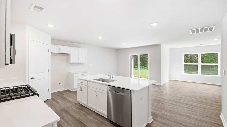 Kitchen and island with quartz countertops.