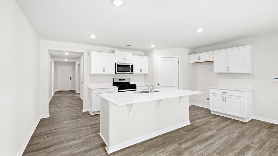 Kitchen and island with quartz countertops.