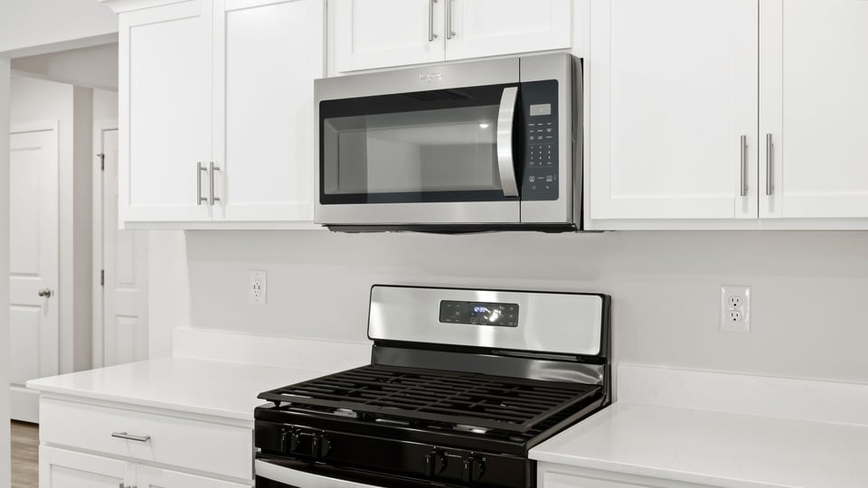 Kitchen and island with quartz countertops.