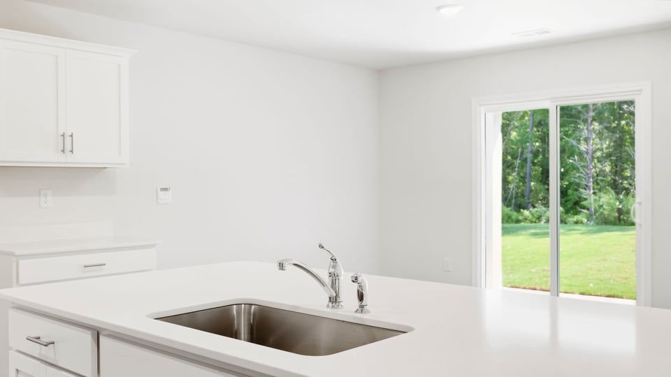 Kitchen and island with quartz countertops.