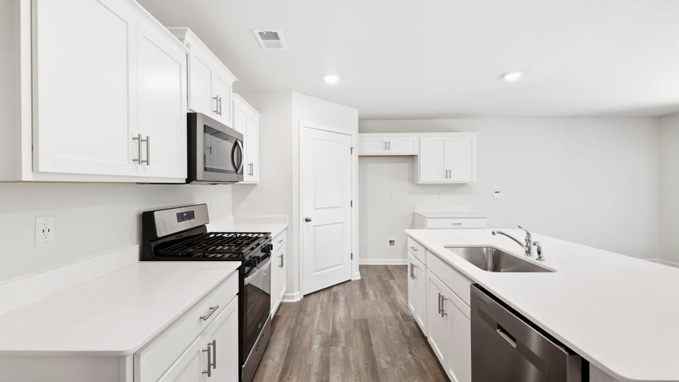 Kitchen and island with quartz countertops.