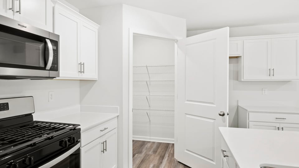 Kitchen and island with quartz countertops.