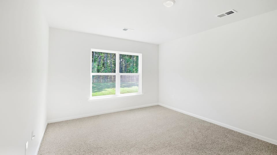 Bedroom with carpet and window.