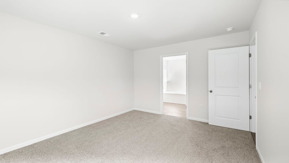 Bedroom with carpet and window.