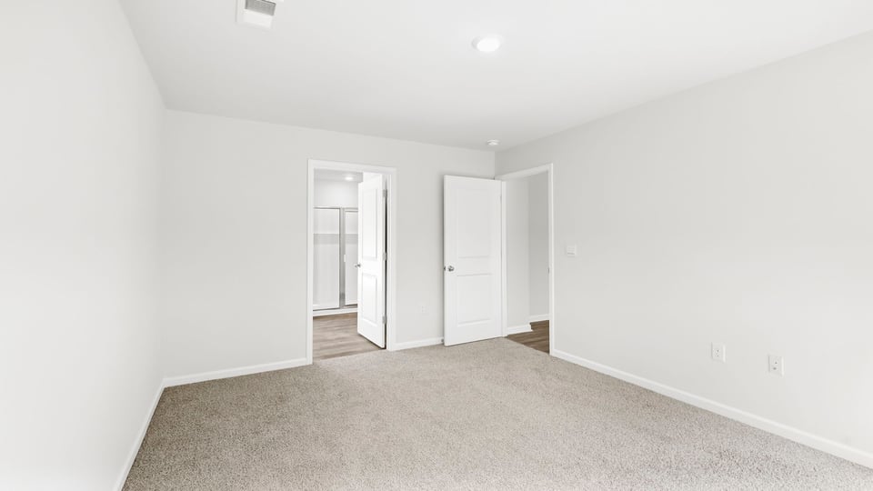 Bedroom with carpet and window.