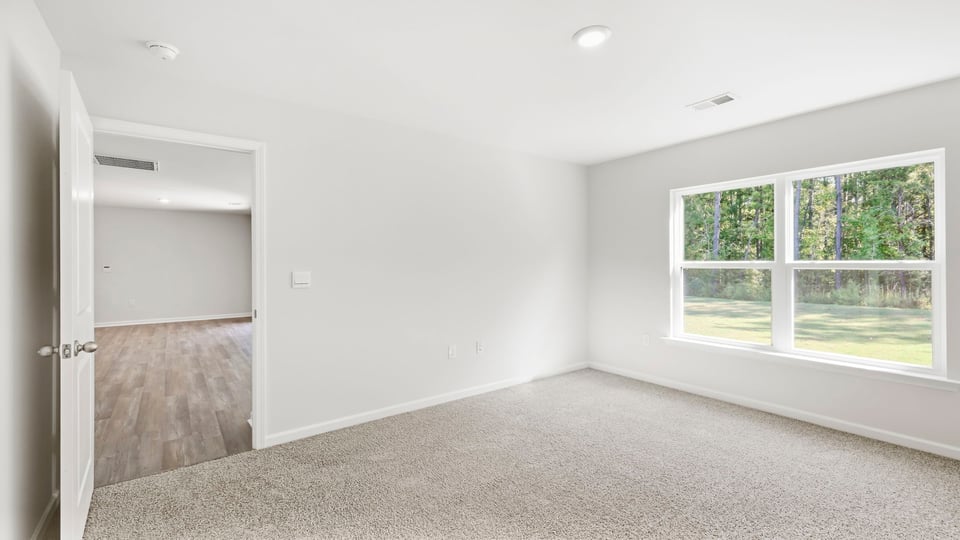 Bedroom with carpet and window.