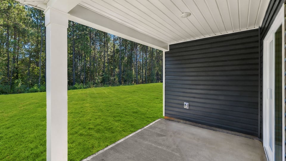 Back exterior of home with covered patio.