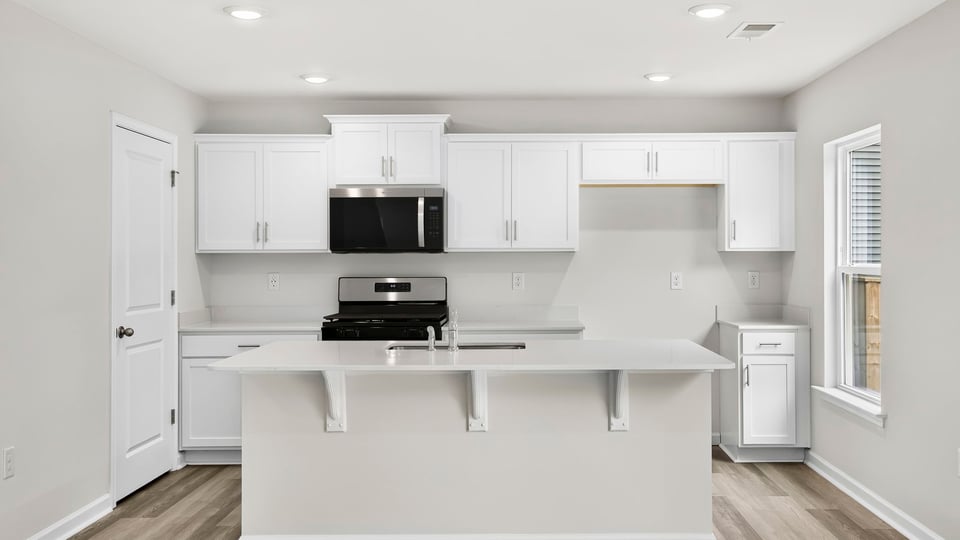 Kitchen and island with quartz countertops.