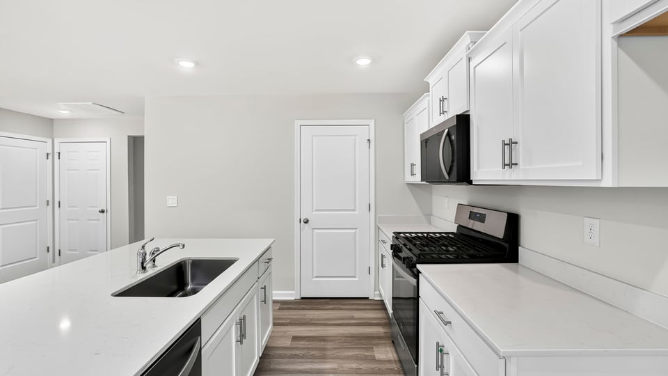 Kitchen and island with quartz countertops.