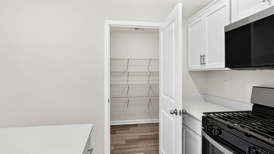Kitchen and island with quartz countertops.