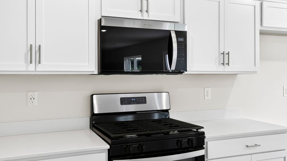 Kitchen and island with quartz countertops.