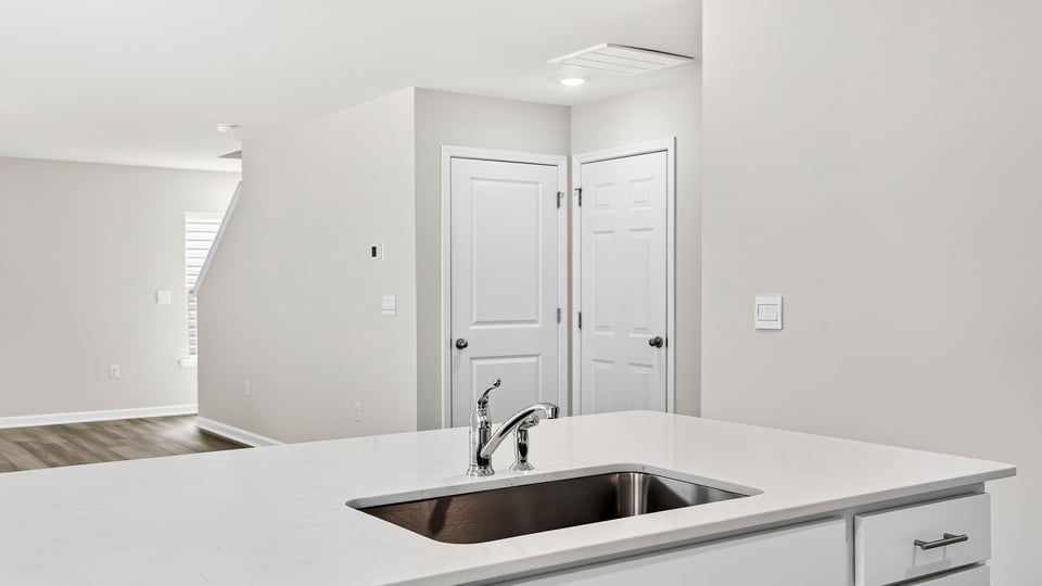 Kitchen and island with quartz countertops.