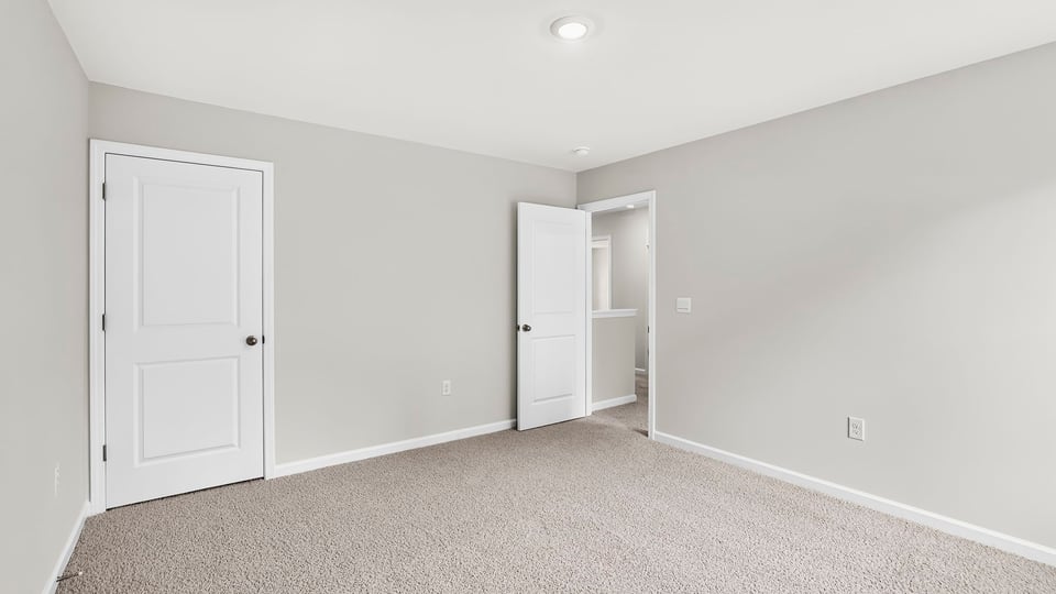 Bedroom with carpet and window.