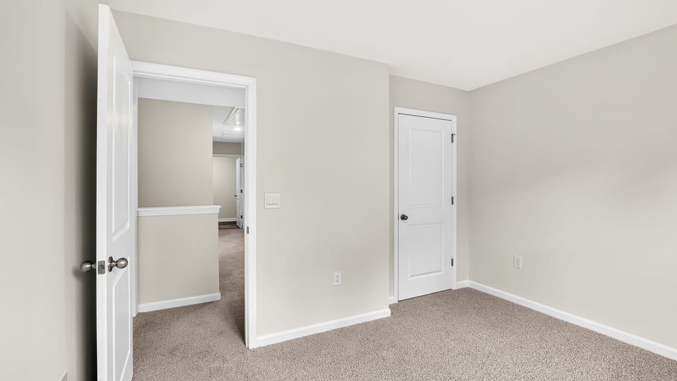 Bedroom with carpet and window.