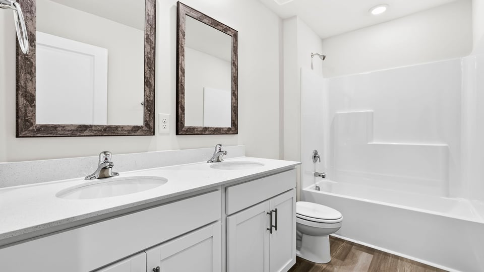 Bathroom with double vanity sink and bathtub.