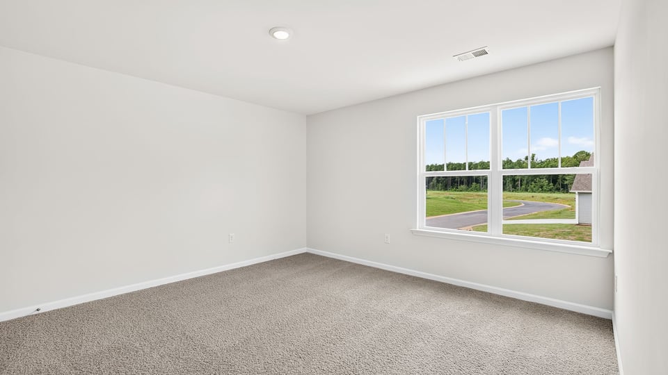 Bedroom with carpet and window.