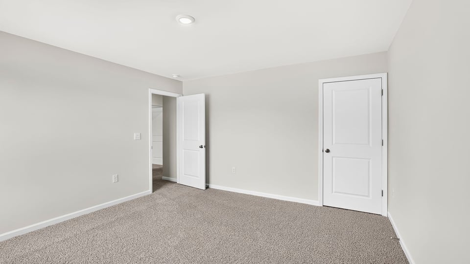 Bedroom with carpet and window.