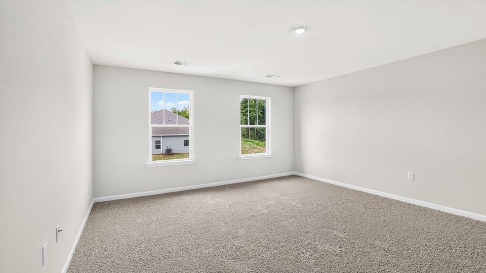 Bedroom with carpet and window.
