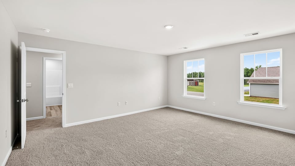 Bedroom with carpet and window.