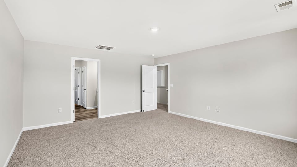 Bedroom with carpet and window.